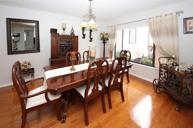 dining room featuring light wood-style flooring and baseboards