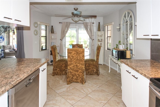 kitchen with visible vents, white cabinetry, stainless steel appliances, and a textured ceiling