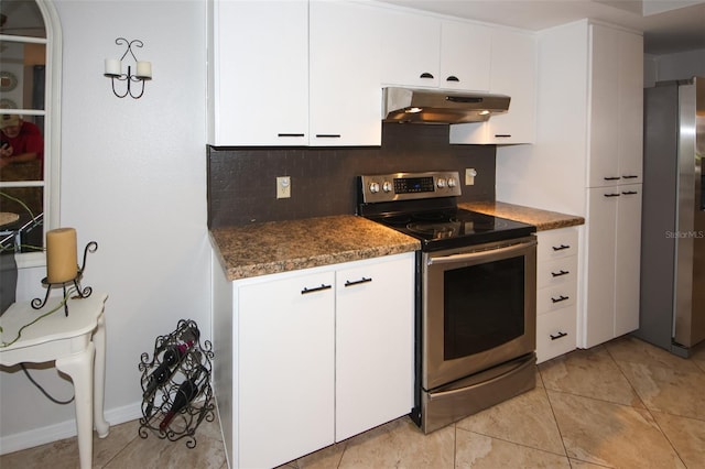 kitchen with decorative backsplash, appliances with stainless steel finishes, white cabinets, light tile patterned flooring, and under cabinet range hood