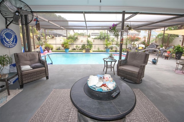 view of swimming pool with glass enclosure, a patio, and a fenced in pool