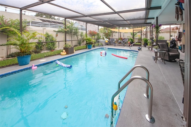 view of pool with a patio, glass enclosure, and a fenced in pool