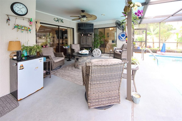 view of patio with a ceiling fan, a lanai, an outdoor pool, and an outdoor hangout area