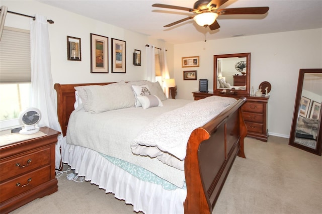 carpeted bedroom with visible vents and ceiling fan