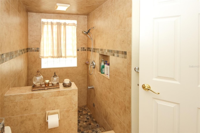 bathroom with tiled shower