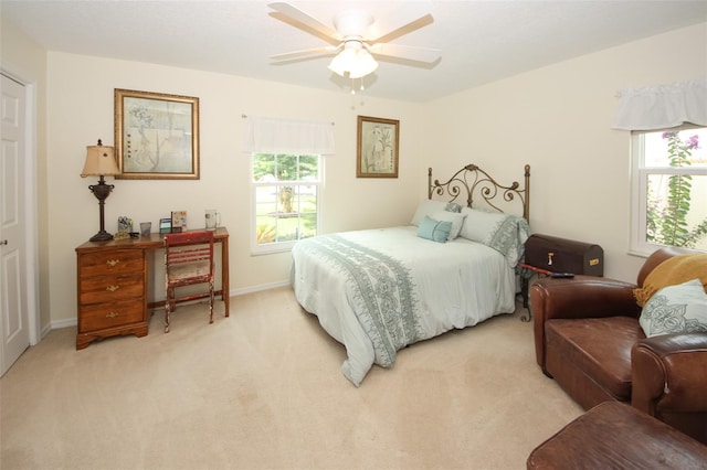 bedroom featuring light colored carpet, ceiling fan, and baseboards