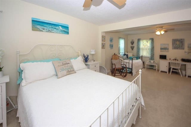 bedroom featuring carpet floors, ceiling fan, and a textured ceiling