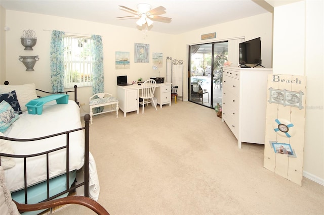 home office featuring a ceiling fan and light colored carpet