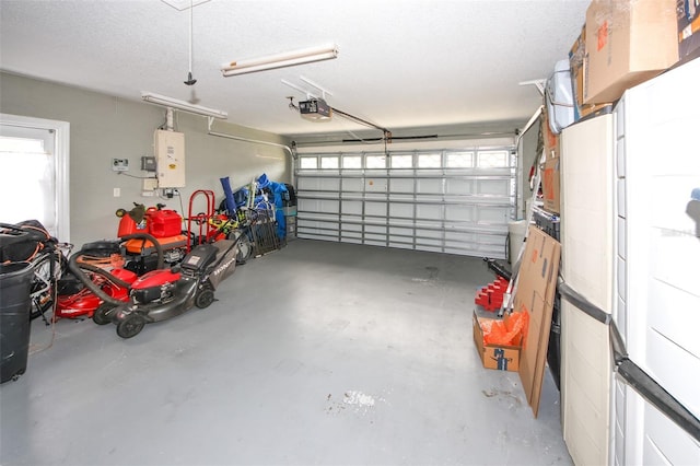 garage featuring a garage door opener and water heater