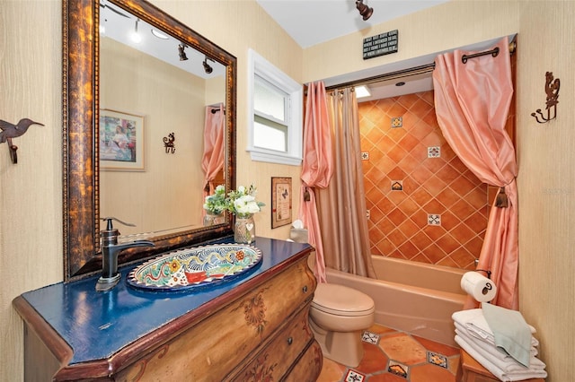 full bathroom featuring shower / bath combo, vanity, and toilet