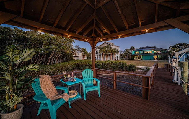 wooden terrace featuring a gazebo