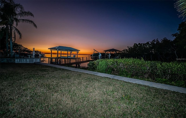 view of dock with a lawn