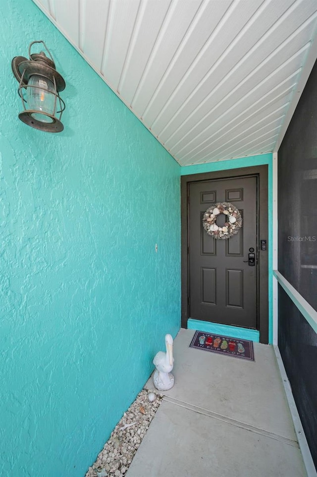 doorway to property with stucco siding