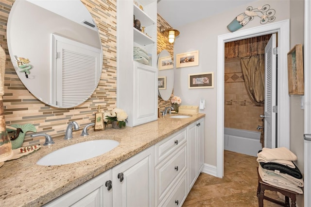 bathroom featuring double vanity, a sink, visible vents, and decorative backsplash