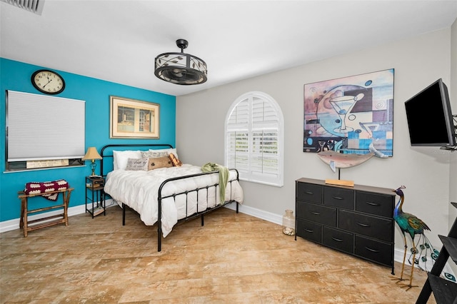 bedroom featuring visible vents and baseboards