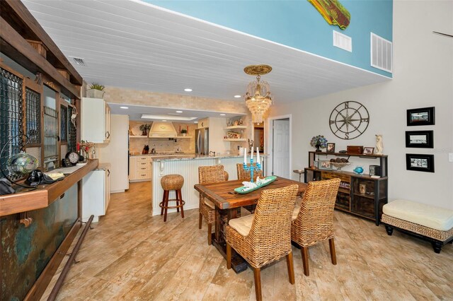 dining area with an inviting chandelier, visible vents, and recessed lighting