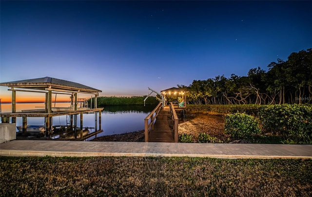 dock area with a water view and boat lift