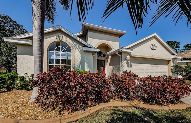 view of front facade featuring stucco siding and a garage