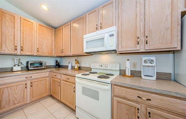 kitchen with light brown cabinets, light tile patterned floors, and white appliances