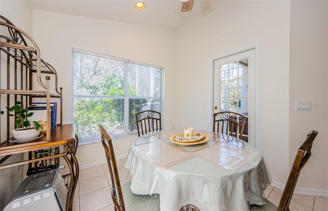 dining space with plenty of natural light, light tile patterned flooring, and baseboards