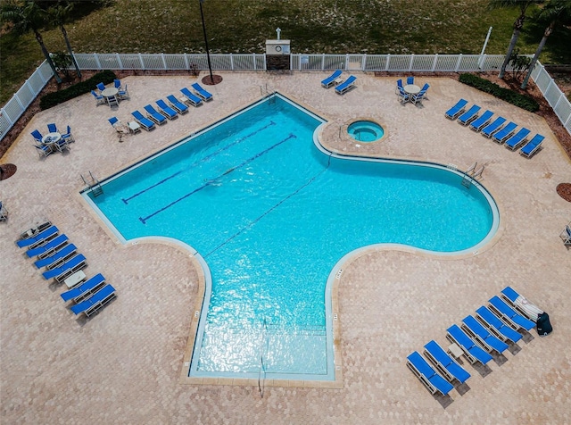 view of swimming pool featuring fence