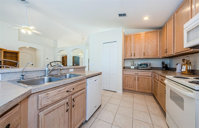 kitchen with white appliances, light tile patterned floors, visible vents, lofted ceiling, and a sink