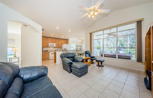 living area with light tile patterned floors, a ceiling fan, lofted ceiling, recessed lighting, and arched walkways