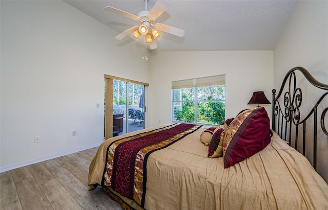 bedroom with baseboards, ceiling fan, lofted ceiling, wood finished floors, and access to outside