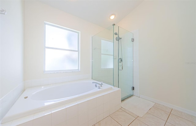 bathroom with tile patterned floors, a shower stall, and a garden tub