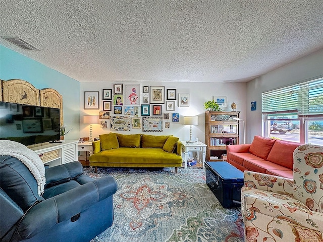 living room featuring visible vents and a textured ceiling