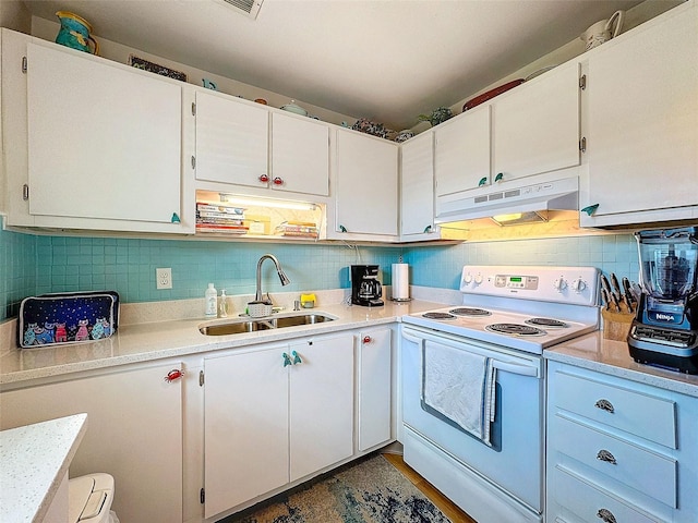 kitchen featuring backsplash, light countertops, white electric range, under cabinet range hood, and a sink