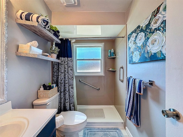 bathroom with curtained shower, vanity, and toilet