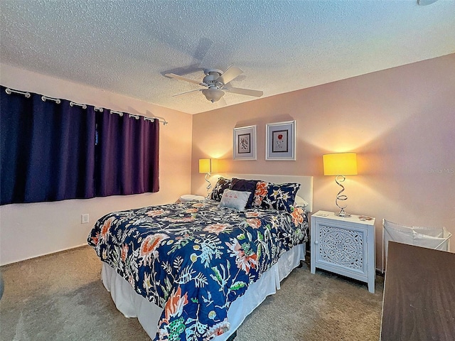 bedroom featuring a textured ceiling, ceiling fan, and carpet flooring