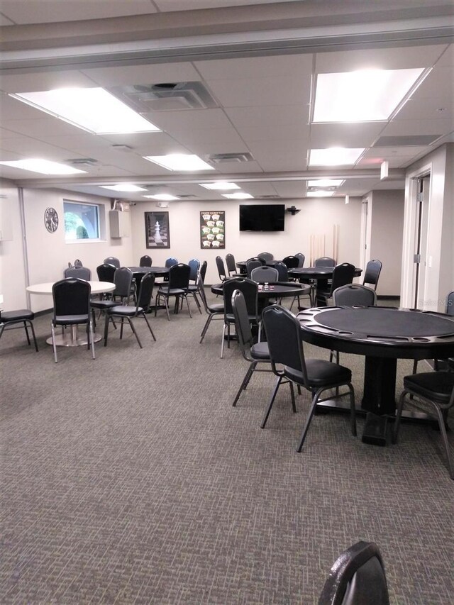 interior space featuring carpet, a drop ceiling, and visible vents