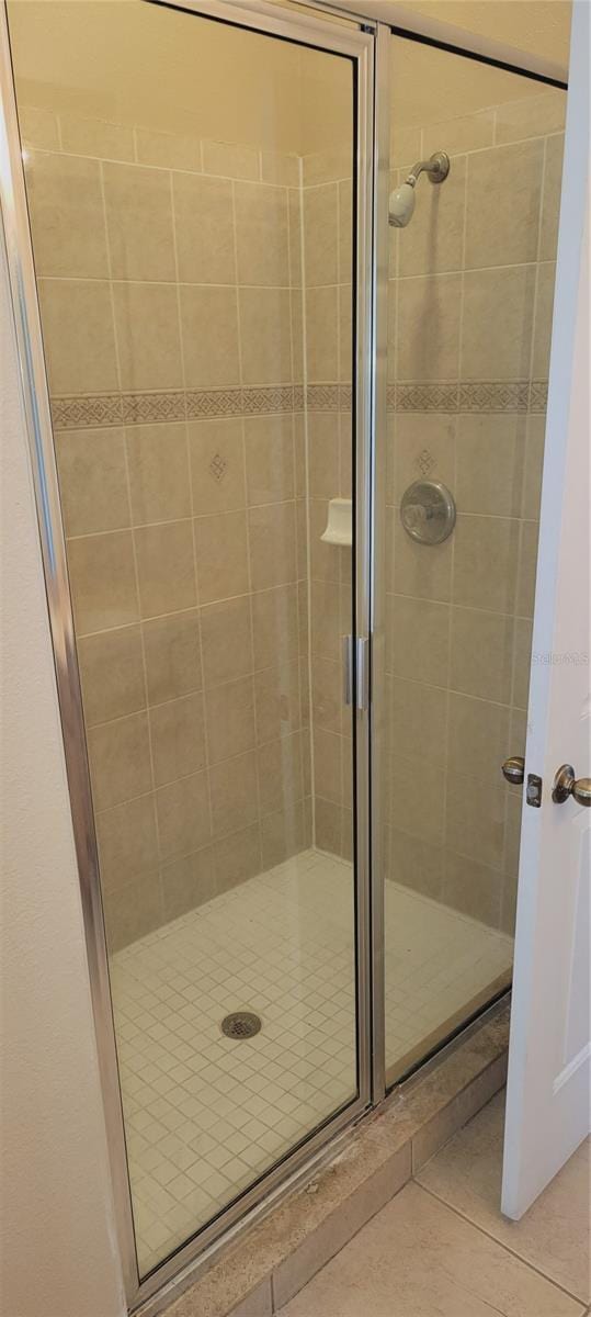 bathroom featuring a stall shower and tile patterned flooring