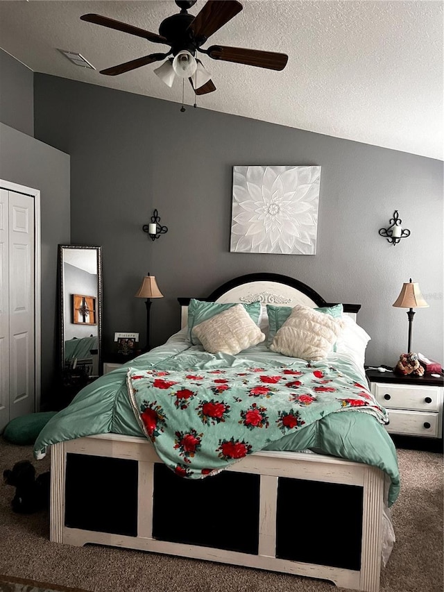 bedroom featuring carpet floors, visible vents, a textured ceiling, and lofted ceiling