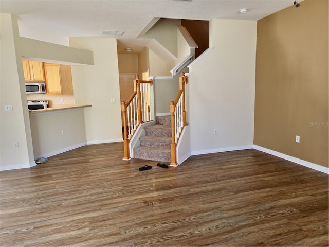 stairs featuring baseboards and wood finished floors