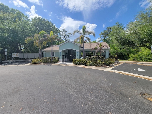 ranch-style house with uncovered parking and stucco siding
