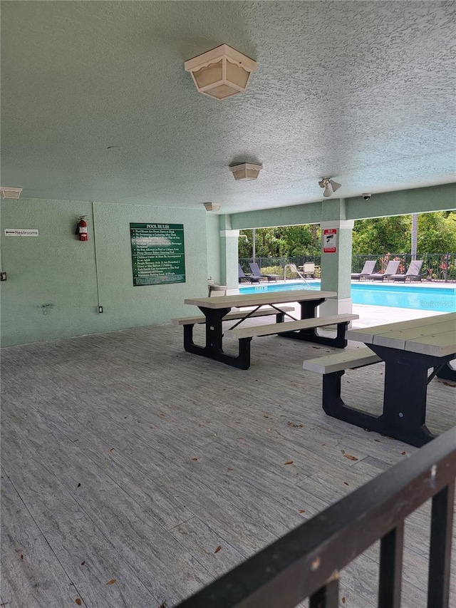 exterior space with a community pool and fence