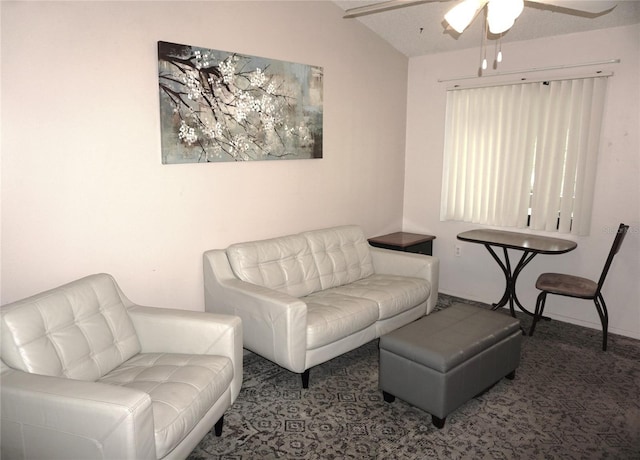 carpeted living area featuring vaulted ceiling and ceiling fan