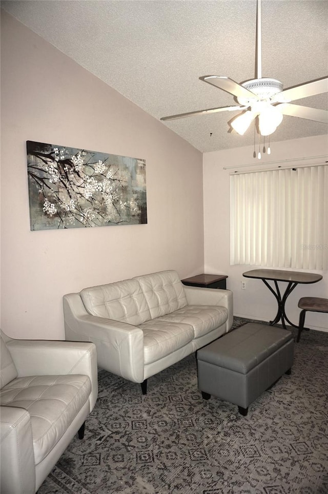 carpeted living area featuring a textured ceiling, vaulted ceiling, and ceiling fan