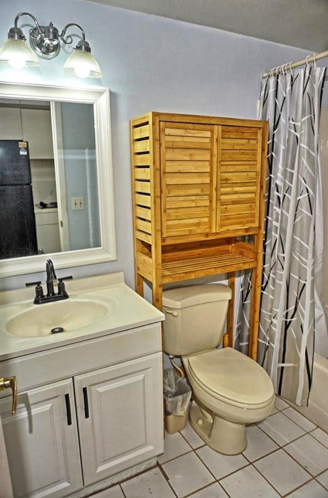 full bathroom featuring vanity, shower / bath combo, tile patterned flooring, and toilet