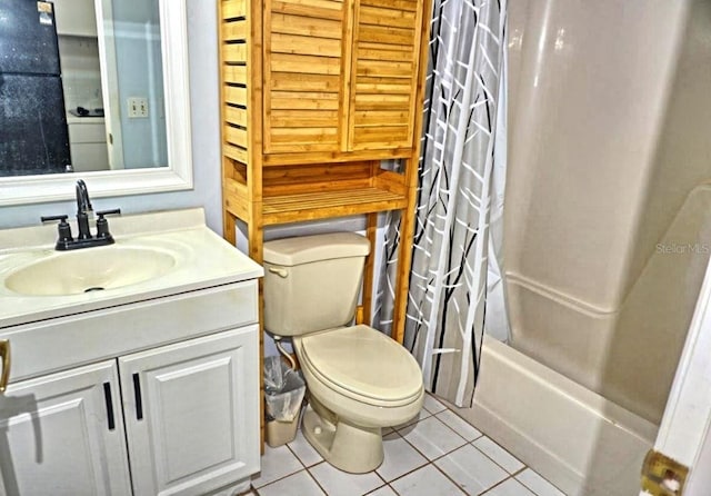 bathroom featuring shower / tub combo, tile patterned flooring, vanity, and toilet