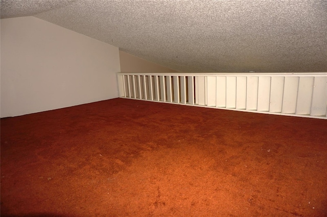 bonus room featuring a textured ceiling, carpet flooring, and vaulted ceiling