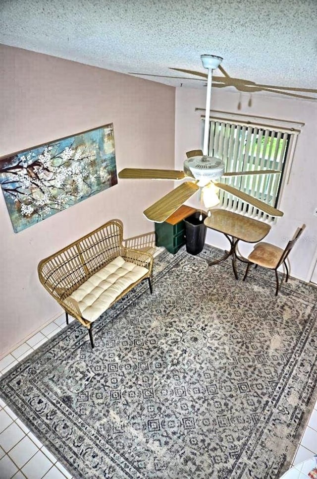 living area featuring vaulted ceiling, a textured ceiling, and tile patterned floors