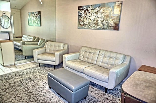 living room featuring tile patterned flooring and vaulted ceiling