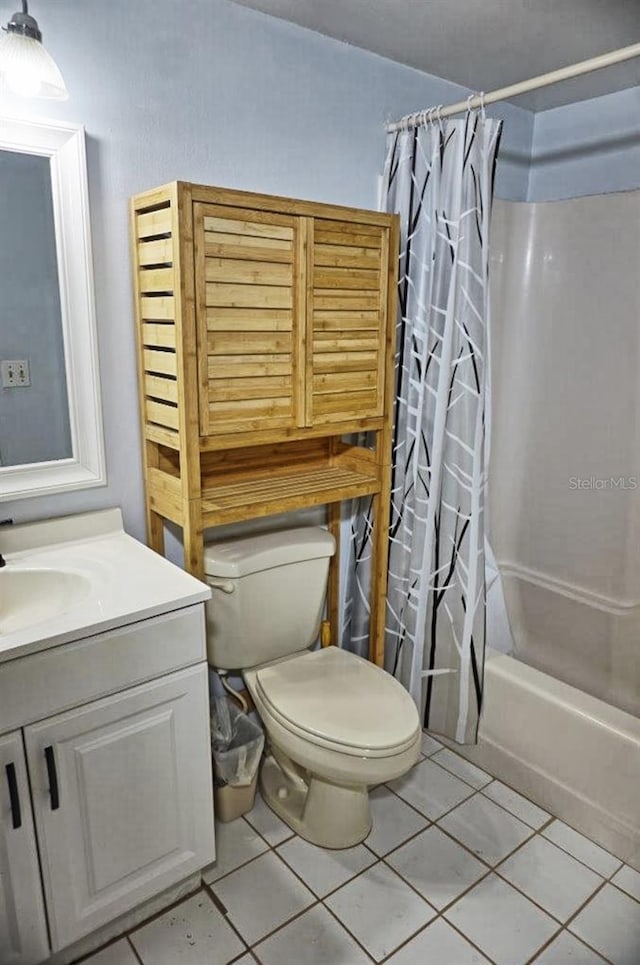 full bath featuring tile patterned flooring, shower / tub combo, toilet, and vanity