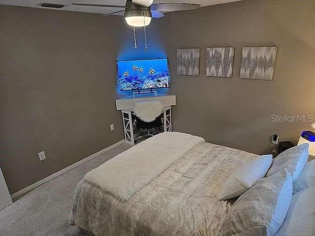 bedroom featuring ceiling fan, carpet flooring, visible vents, and baseboards