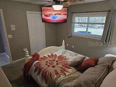 bedroom featuring a closet, a ceiling fan, and baseboards