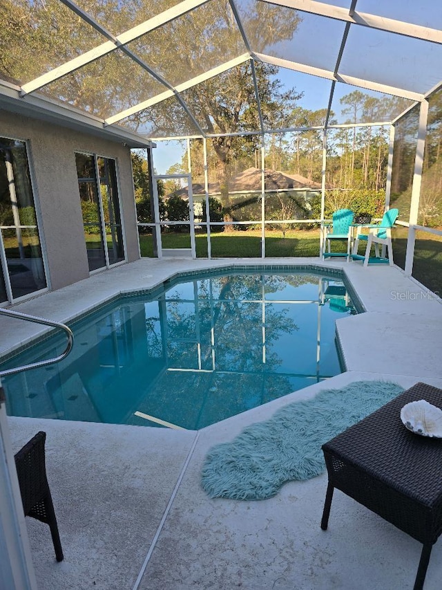 outdoor pool with a patio area and a lanai