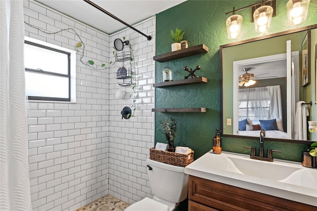 ensuite bathroom featuring toilet, vanity, tiled shower, and ensuite bathroom